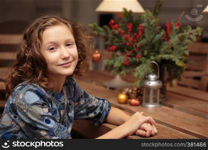 portrait of smiling curly little girl indoors