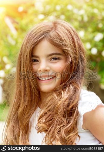 Portrait of smiling cute little girl having fun outdoors, playing in summer park, enjoying summer holidays, happiness concept