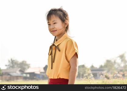 Portrait of smiling cute little girl outdoors in summer day.