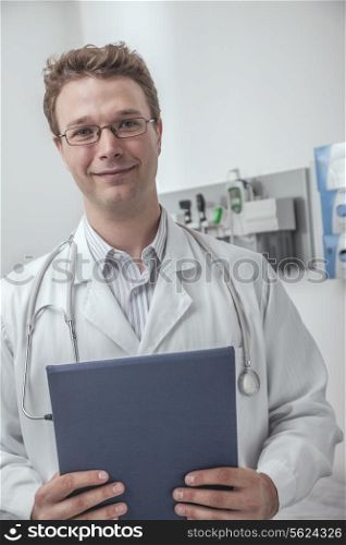 Portrait of smiling doctor holding a clipboard