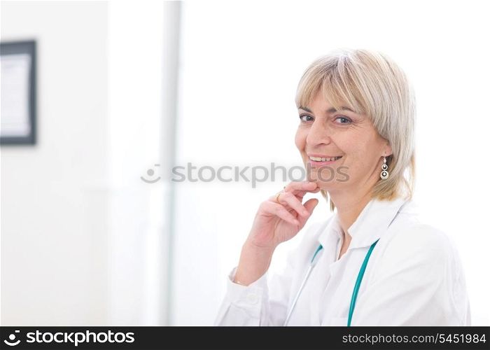 Portrait of smiling elderly doctor