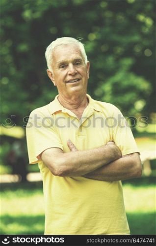 Portrait of smiling elderly man outdoor in park. Portrait of smiling elderly man