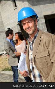 Portrait of smiling entrepreneur standing on construction site