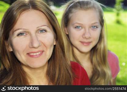 Portrait of smiling family of mother and her teenage daughter