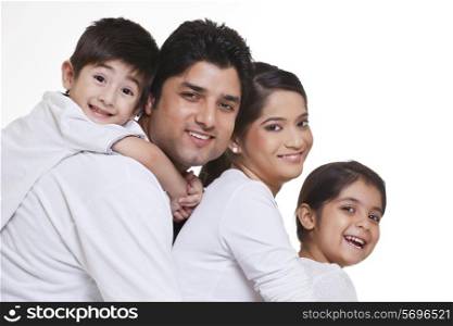 Portrait of smiling family over white background