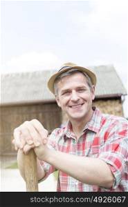 Portrait of smiling farmer wearing hat at farm