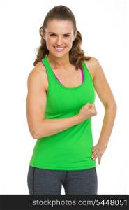Portrait of smiling female athlete showing biceps