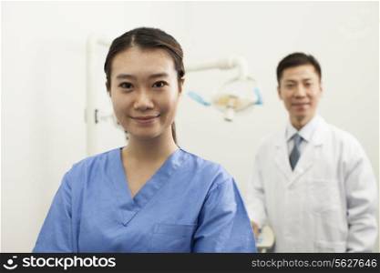 Portrait Of Smiling Female Dental Assistant In Clinic