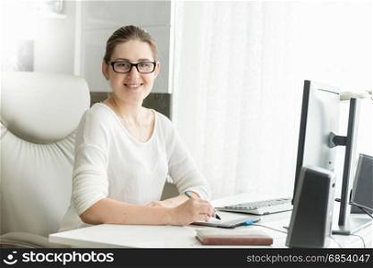 Portrait of smiling female designer working at office