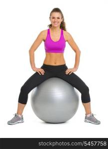 Portrait of smiling fitness young woman on fitness ball