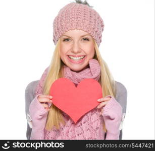 Portrait of smiling girl in winter clothes showing heart shaped postcard