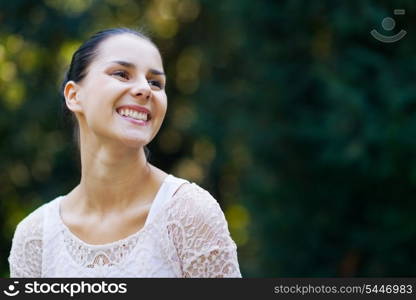 Portrait of smiling girl in woods looking on copy space