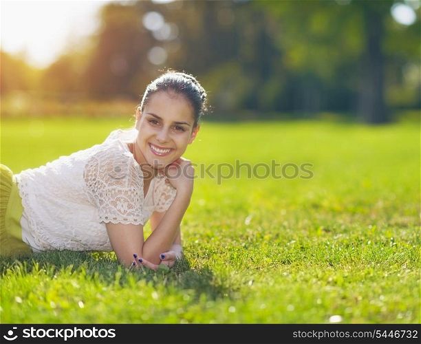 Portrait of smiling girl laying on meadow