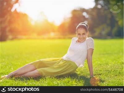 Portrait of smiling girl on meadow laying on meadow