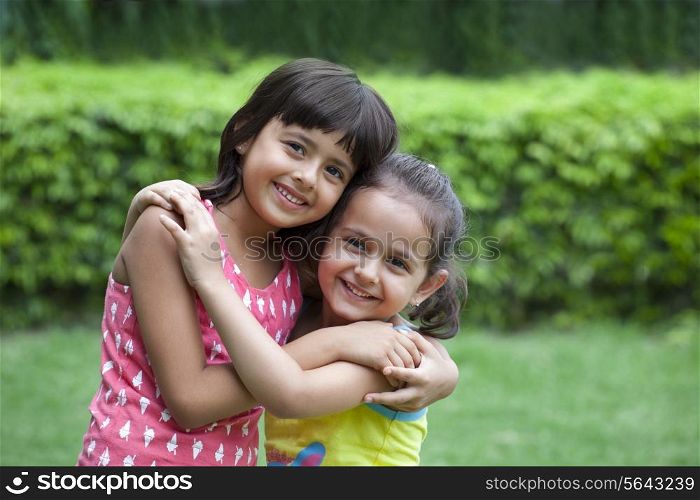 Portrait of smiling girls hugging each other