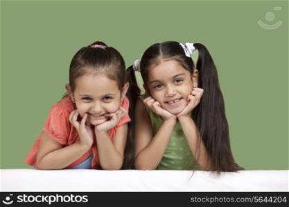 Portrait of smiling girls over colored background
