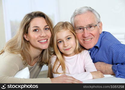 Portrait of smiling grandpa, mother and child