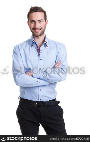 Portrait of smiling happy man in blue shirt and black pants with crossed arms - isolated on white.&#xA;
