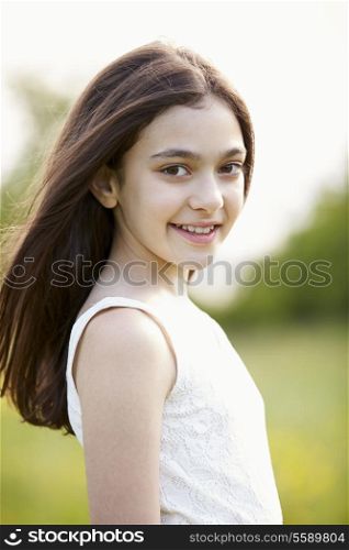Portrait Of Smiling Hispanic Girl In Countryside