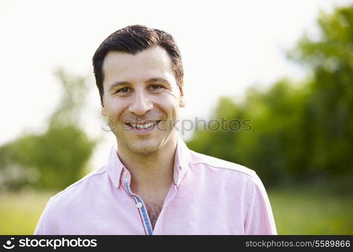 Portrait Of Smiling Hispanic Man In Countryside