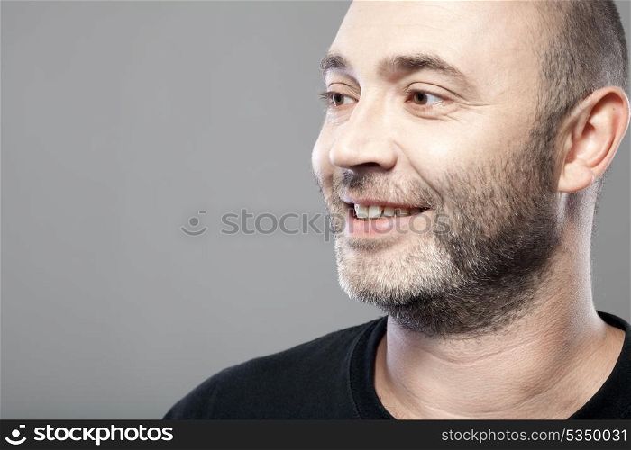 portrait of smiling man isolated on gray background with copyspace