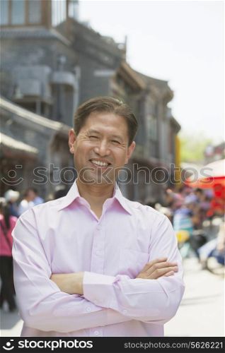 Portrait of smiling mature man standing in outdoors in Beijing