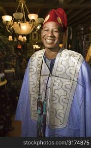 Portrait of smiling mid-adult African-American man wearing traditional African clothing.