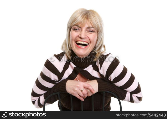 Portrait of smiling middle age woman sitting on chair