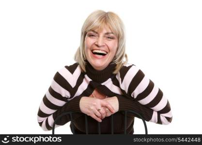 Portrait of smiling middle age woman sitting on chair