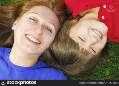 Portrait of smiling mother and son in summer park