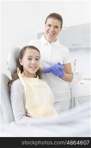 Portrait of smiling patient and dentist at dental clinic