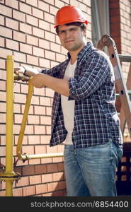 Portrait of smiling plumber repairing pipes