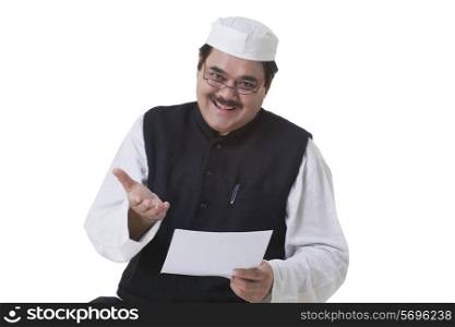 Portrait of smiling politician holding document