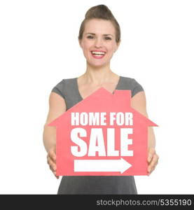 Portrait of smiling realtor showing home for sale sign. HQ photo. Not oversharpened. Not oversaturated. Portrait of smiling realtor showing home for sale sign isolated