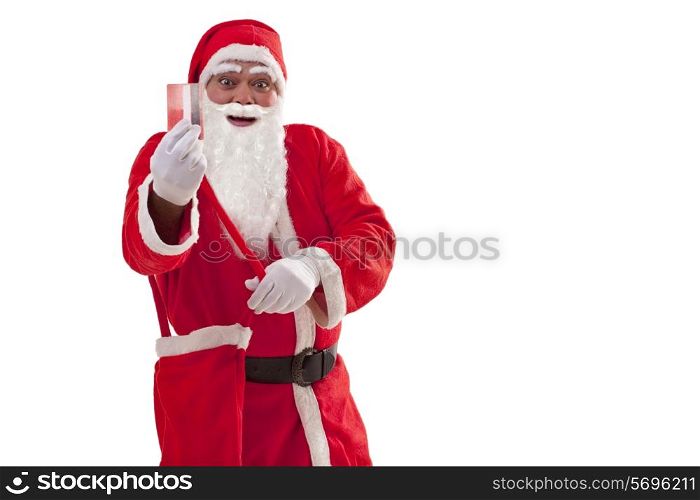 Portrait of smiling Santa Claus showing credit card over white background