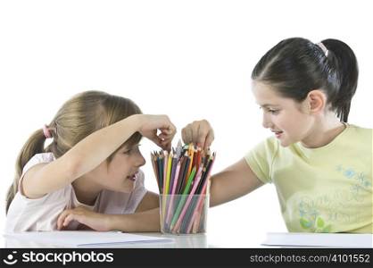 Portrait of smiling schoolchildren draws a picture.