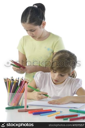 Portrait of smiling schoolchildren draws a picture.