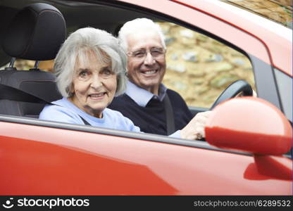 Portrait Of Smiling Senior Couple Out For Drive In Car