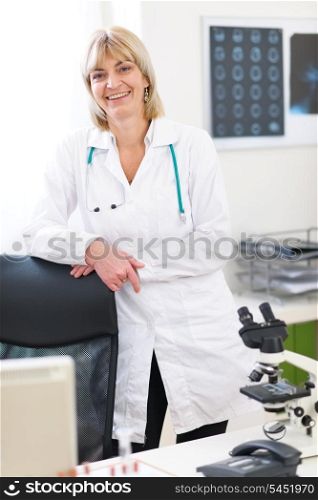 Portrait of smiling senior doctor woman at laboratory