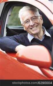 Portrait Of Smiling Senior Man Driving Car