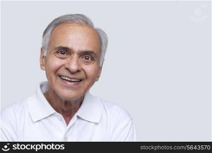 Portrait of smiling senior man over white background