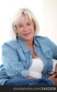 Portrait of smiling senior woman with blue shirt