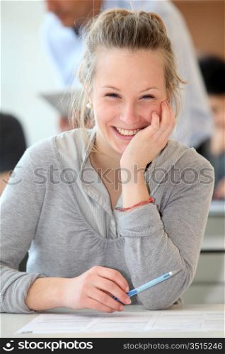 Portrait of smiling student girl in class