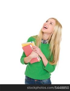 Portrait of smiling student girl looking up on copy space