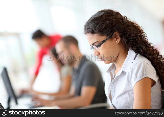 Portrait of smiling student in front of laptop computer