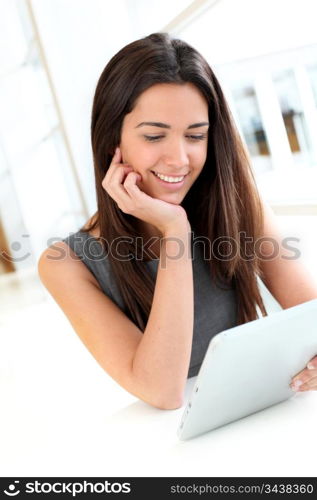 Portrait of smiling student using electronic tablet