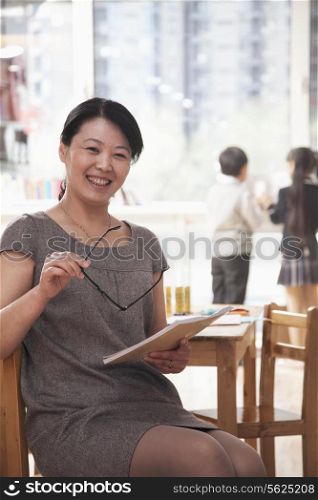 Portrait of smiling teacher in the classroom, Beijing