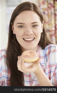 Portrait Of Smiling Teenage Girl On Eating Donut