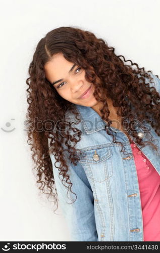 Portrait of smiling teenager leaning on wall