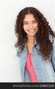 Portrait of smiling teenager leaning on wall
